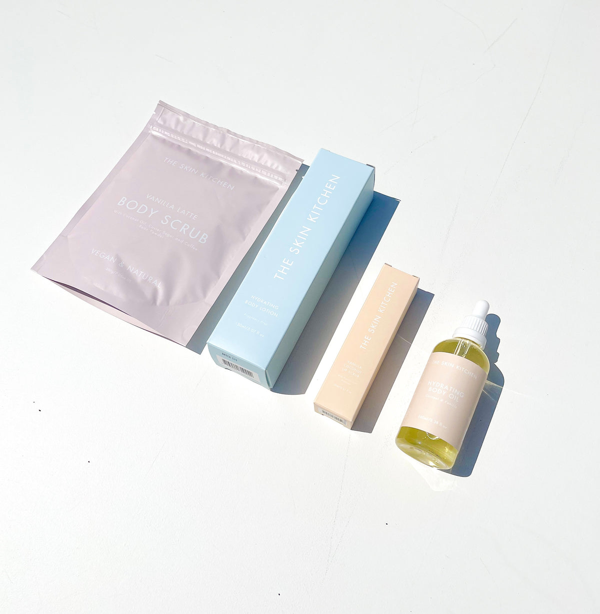 Skincare Bundle. Coconut + Vanilla Body Oil in Limited Edition dropper bottle, Vanilla Latte Body Scrub, Vanilla Coconut Lip Scrub, Hydrating Body Lotion fragrance free,