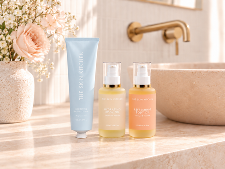 The Skin Kitchen Hydrating Body Lotion, Hydrating Body Oil and Refreshing Body Oil in a bathroom setting.