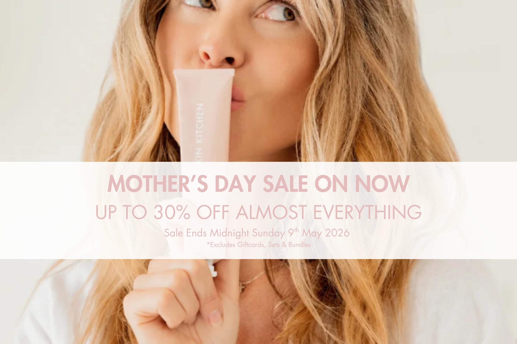 Woman holding Watermelon face mask with a Mother's Day sale banner on a white background.  Up to 30% Off Sale.